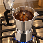 Dolce Mattina Italian Moka Pot in Classic Silver, coffee brewing on the stove