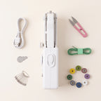 Handheld sewing machine with USB cable, snips, tape measure, bobbins, safety pins and needle threader