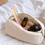 Pink RootGlide packed in a makeup pouch