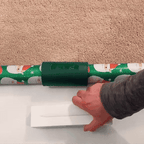 SnapCut sliding along a wrapping paper roll for a straight cut