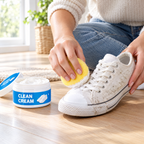 Cleaning a white sneaker with the sponge and cream