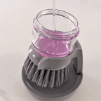 Filling the SudsPress with dish soap and scrubbing a plate
